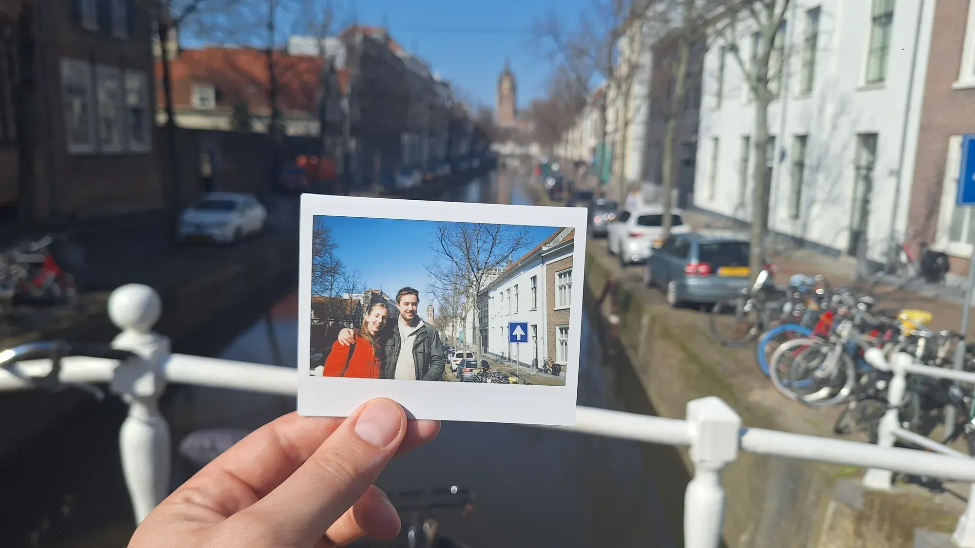 A Polaroid photo held up on the Oude Delft canal during a private walking tour of Delft