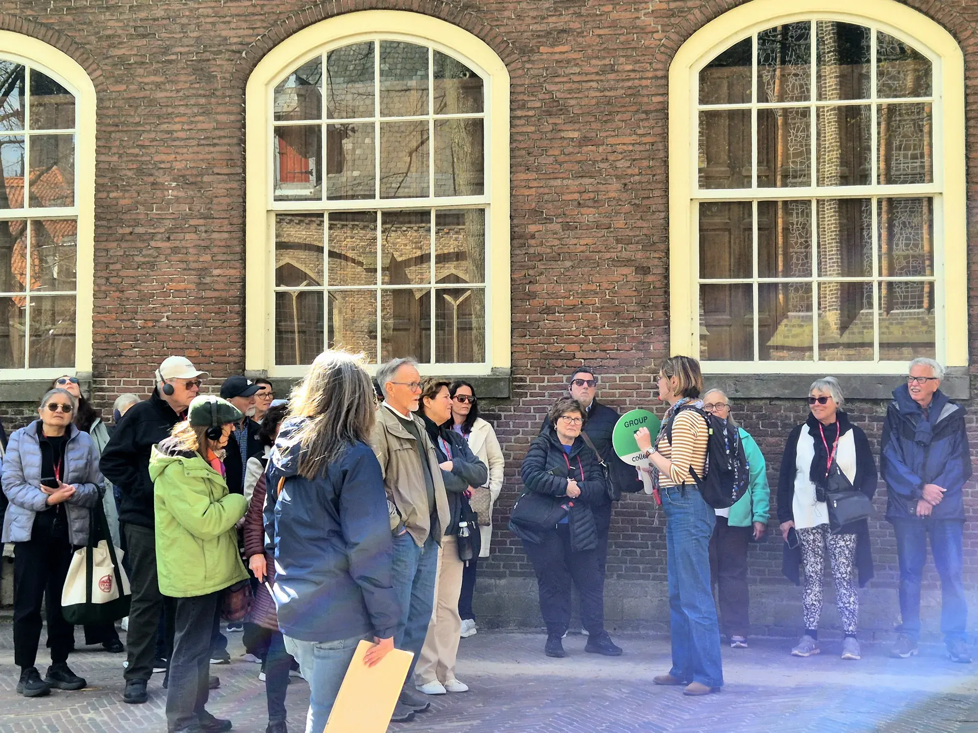 A large group with their guide on a private walking tour in Delft