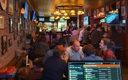 A busy pub interior with a quiz scoreboard, the kind of finish used for The Delft Challenge prize ceremony