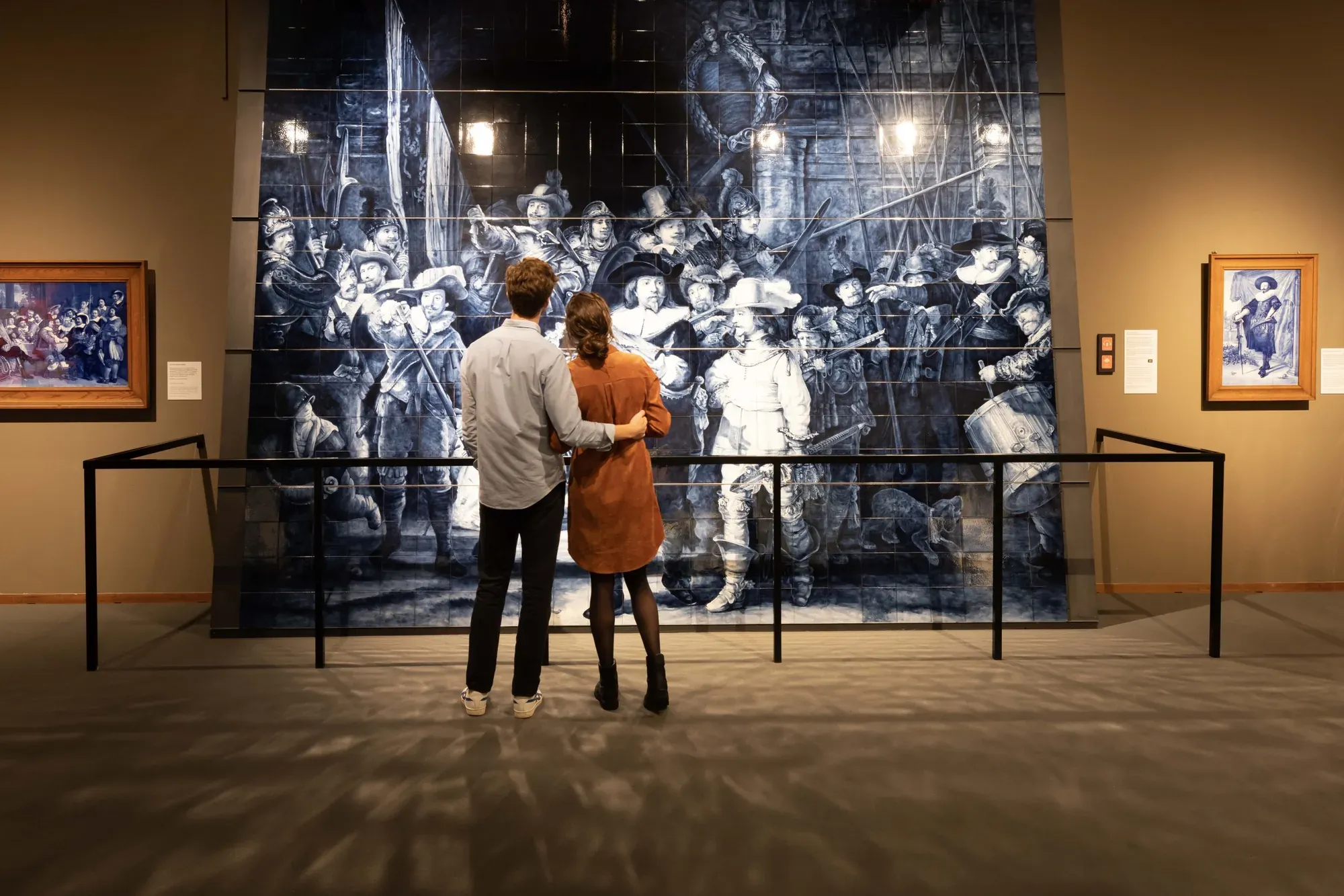 Visitors in front of the Delft Blue Night Watch tile panel at Royal Delft
