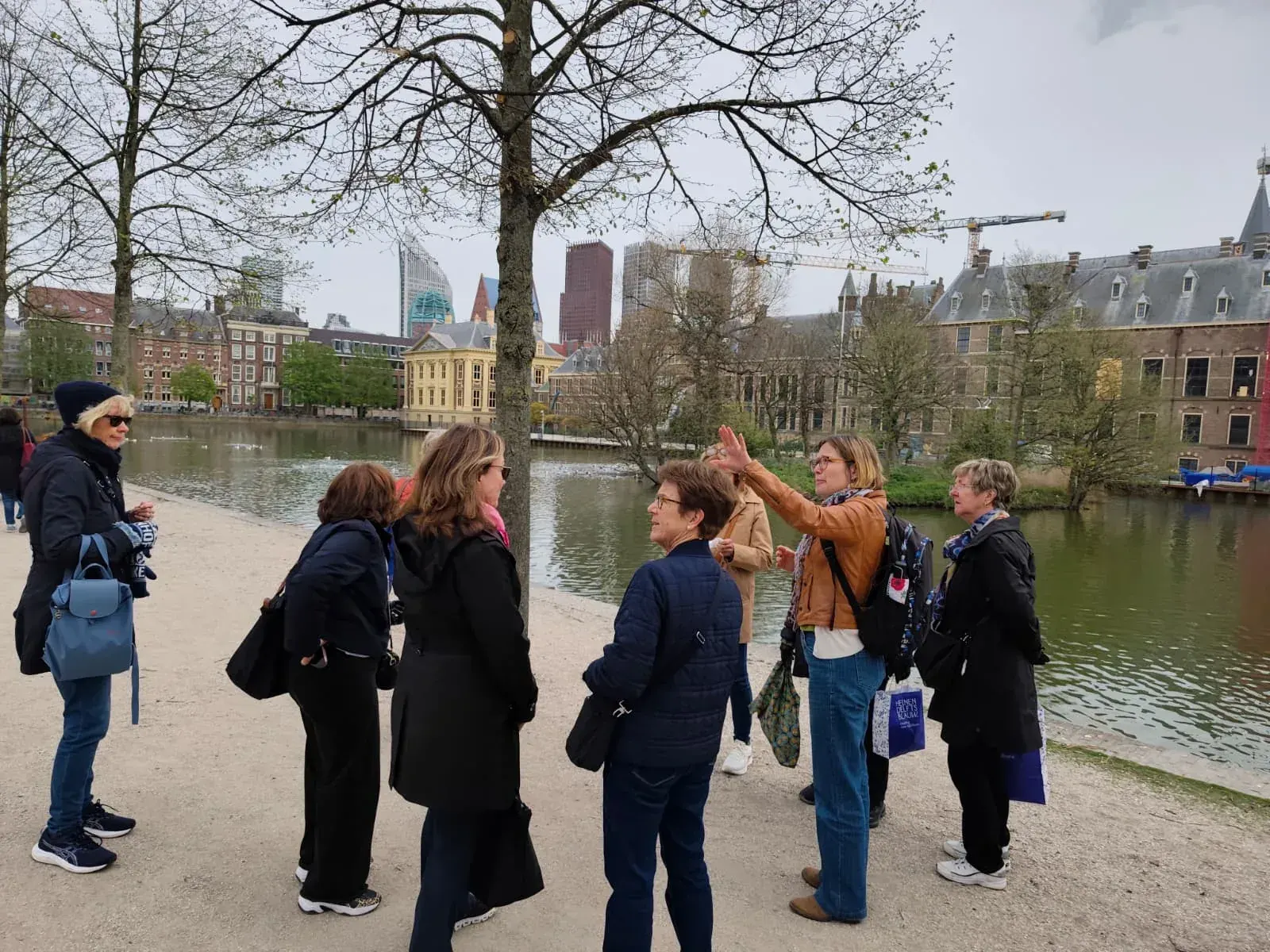 A guide and a small private group beside the Hofvijver on a walking tour of The Hague