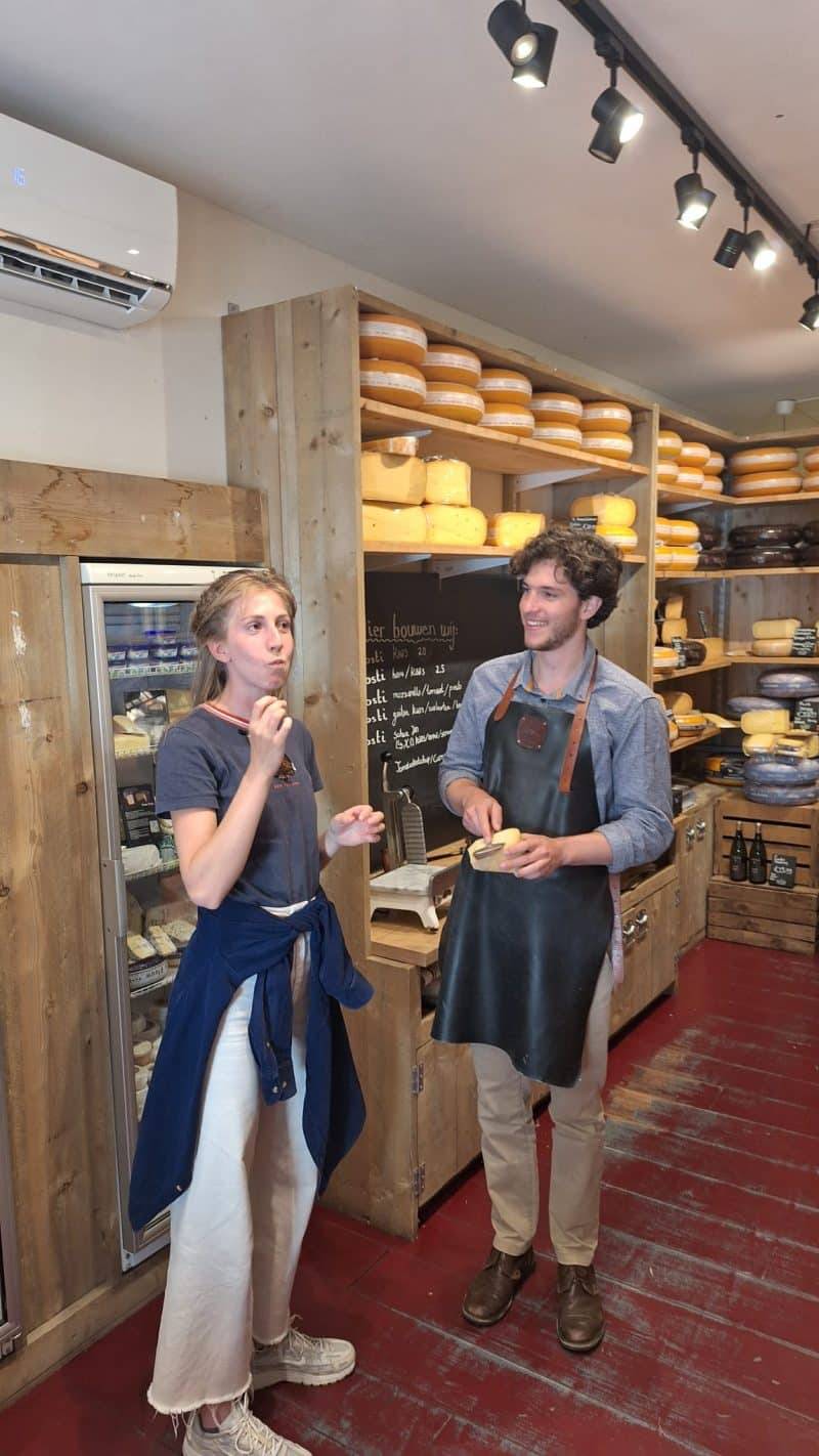Woman tasting a piece of cheese during a Dutch food & drink tour in Delft.